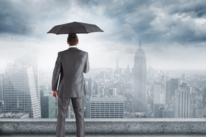 man-suit-umbrella-looking-city_1134-502